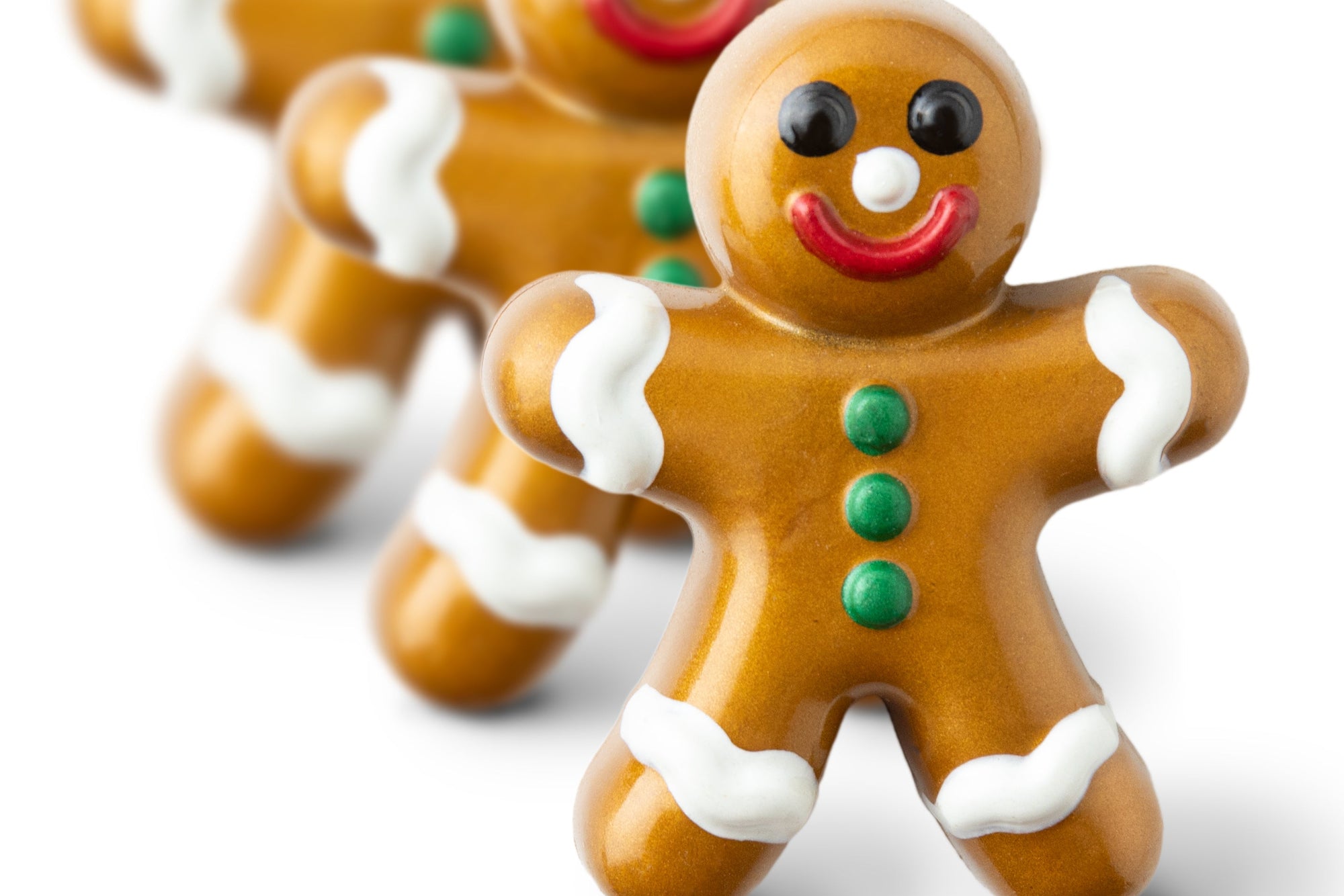 Gingerbread cookie-shaped chocolate bar in a decorative box on a green fabric background